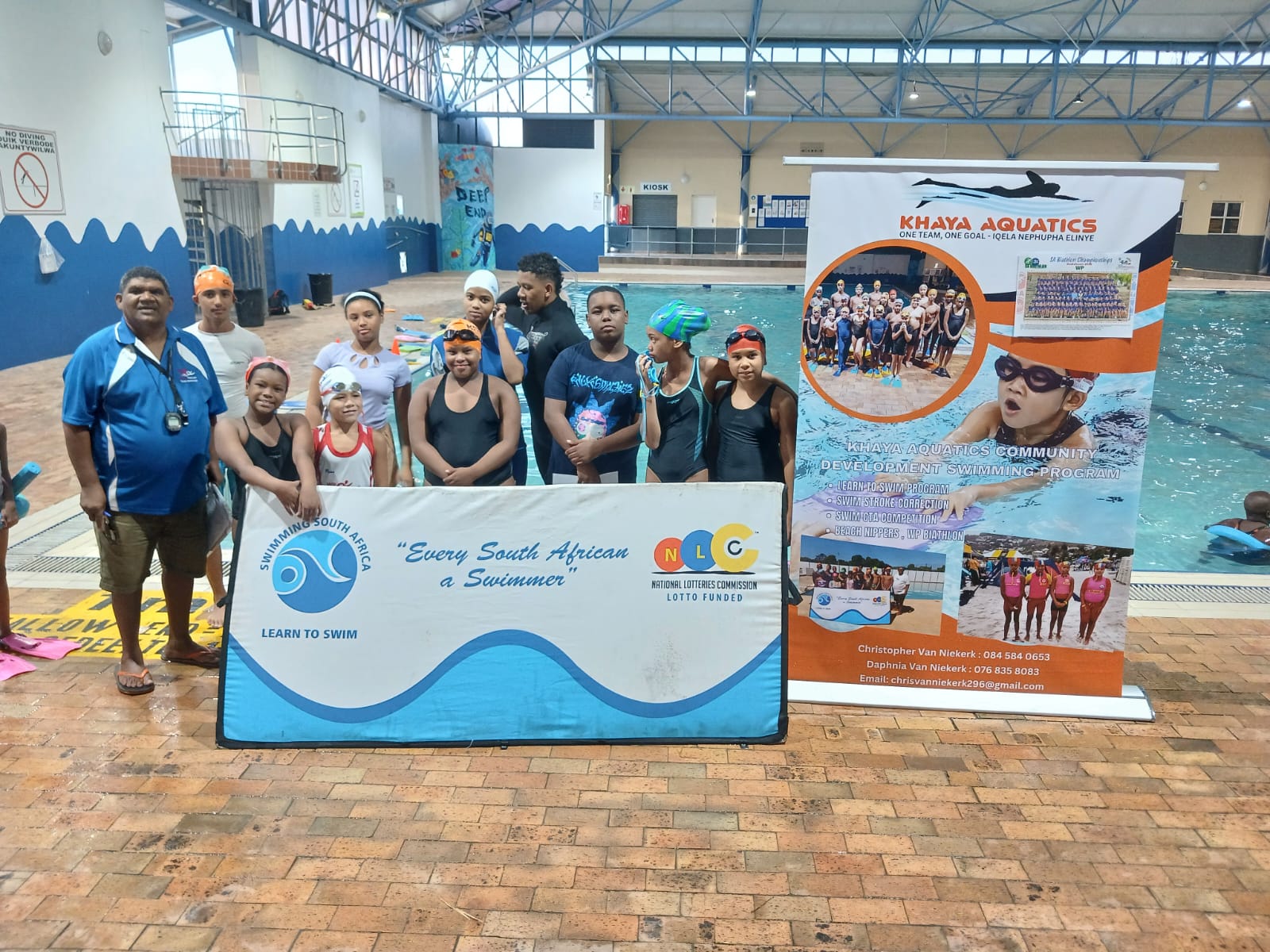 Swimmers lined up with coach