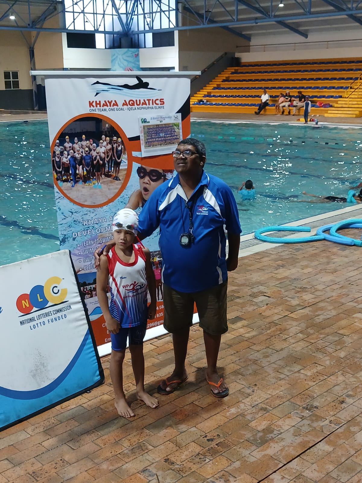 Coach Christopher Van Niekerk with the youngest club swimmer
