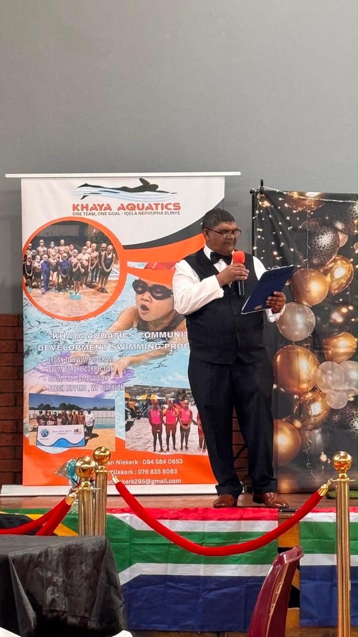 Khaya Aquatics swimmer holding certificate and trophy