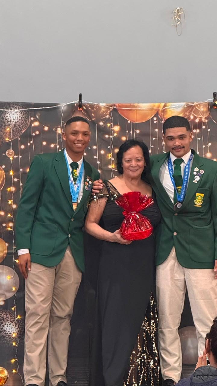 Khaya Aquatics team raising trophies at the awards ceremony